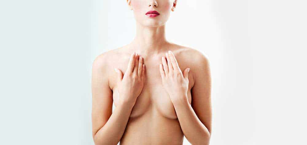 Woman covering breast with hands