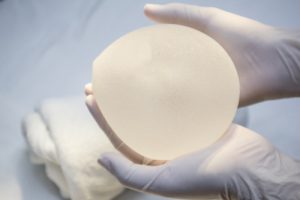 Hands Holding Breast Silicone Implant