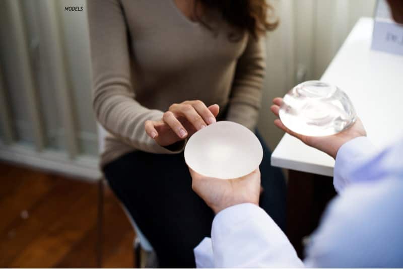 woman at breast implant consultation, choosing breast implants.